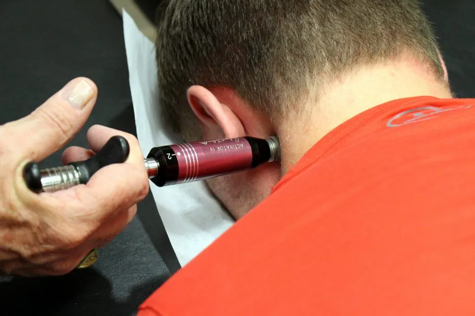 Man treated with the activator method for neck pain