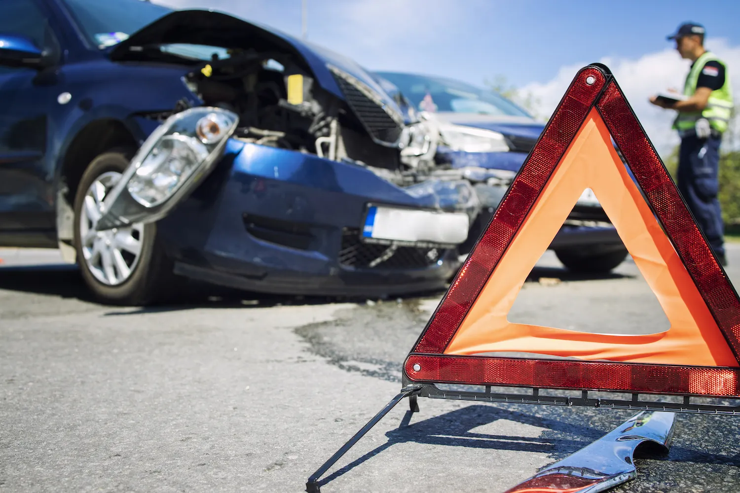 Car collision with a warning triangle in front