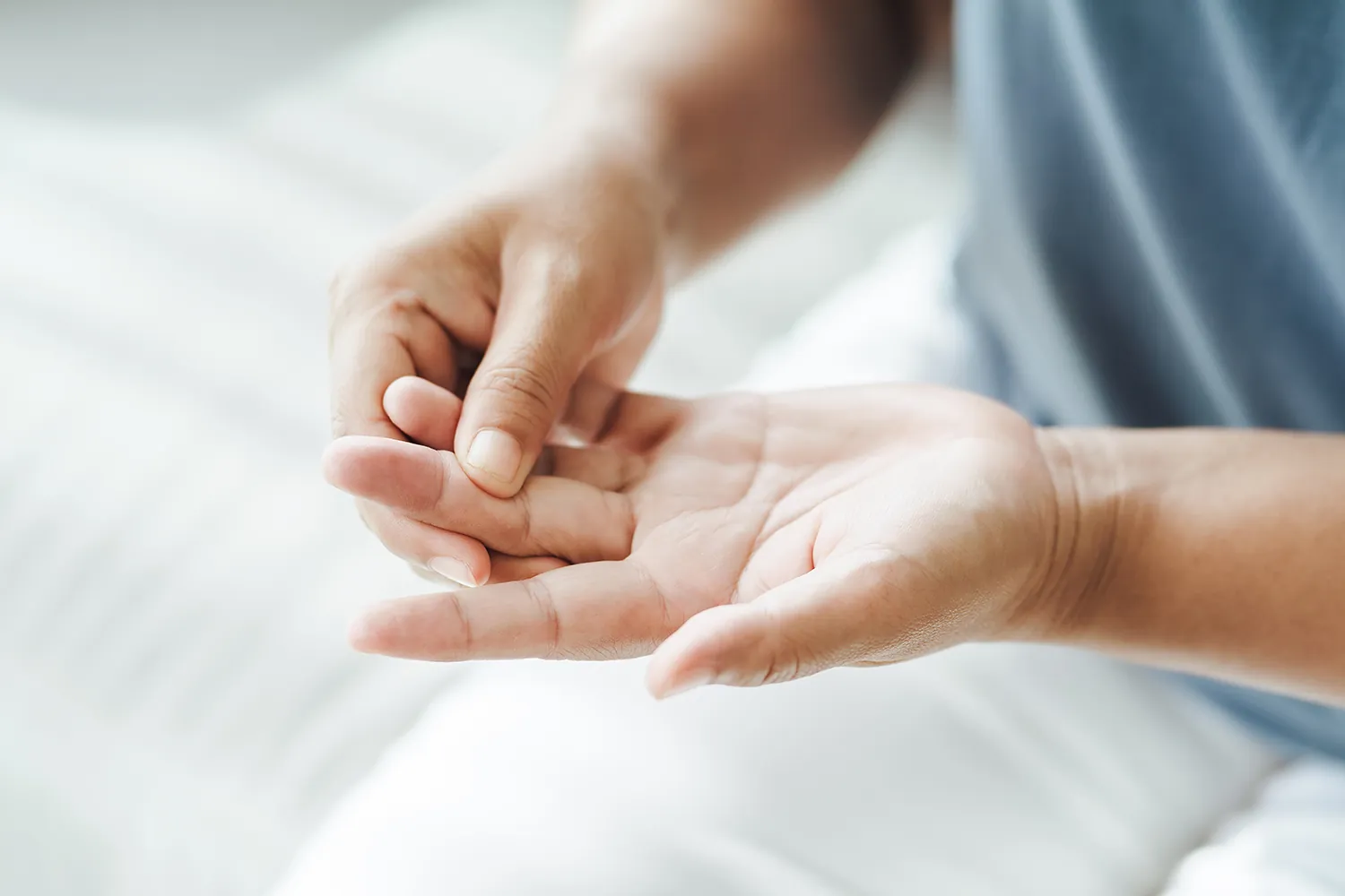 Woman holding her fingers due to carpal tunnel pain