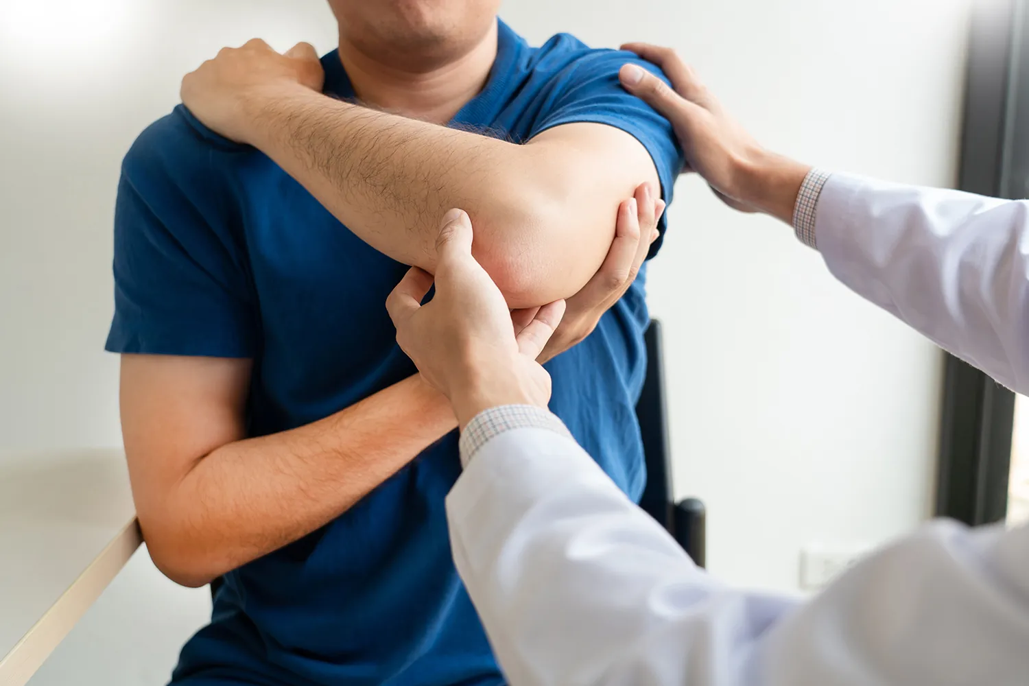 Doctor examining a patient's shoulder