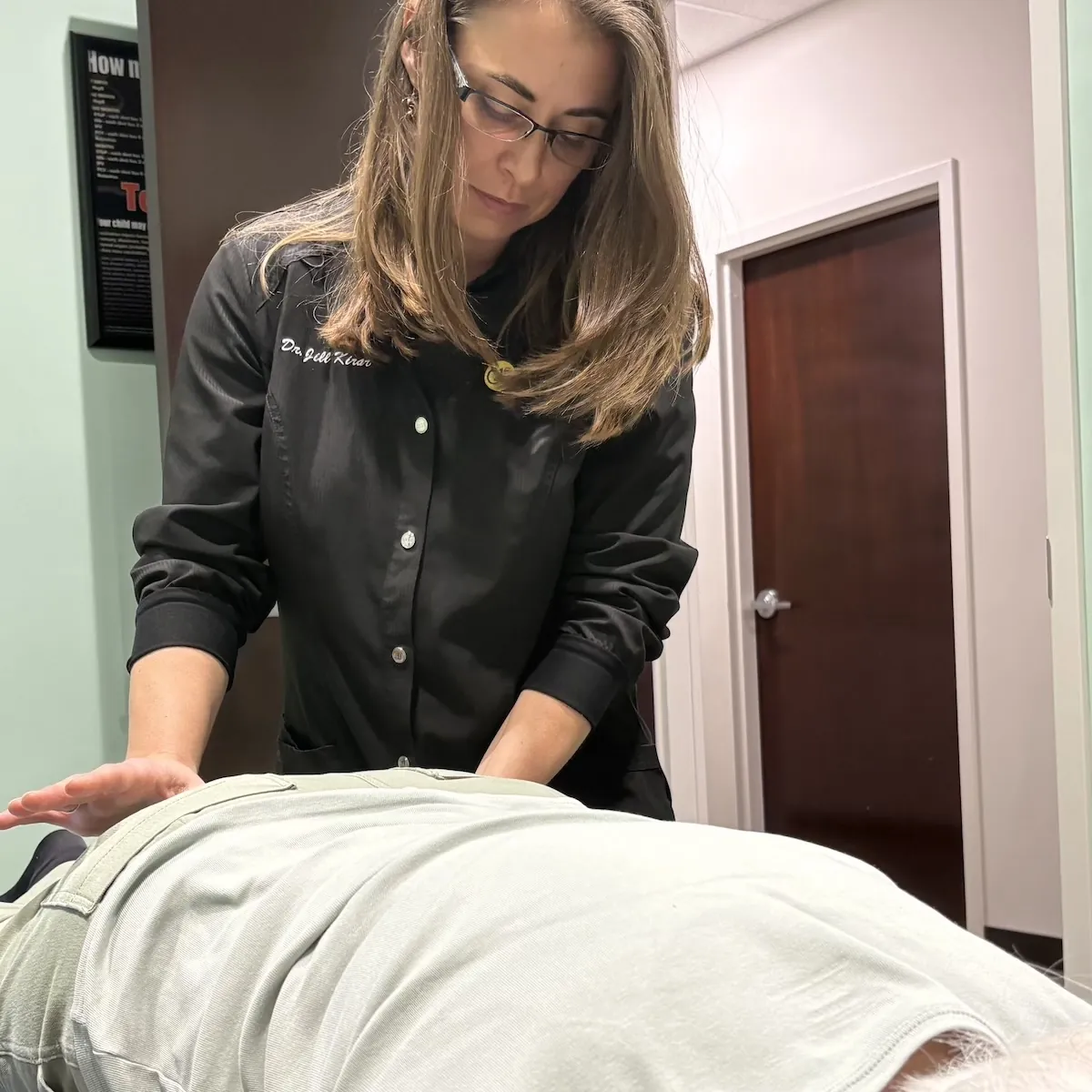 Chiropractor doing hip pain treatment