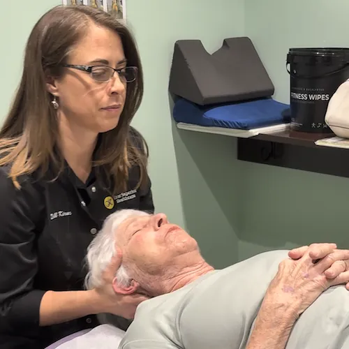 Dr. Jill Kirar adjusting an older patient's neck