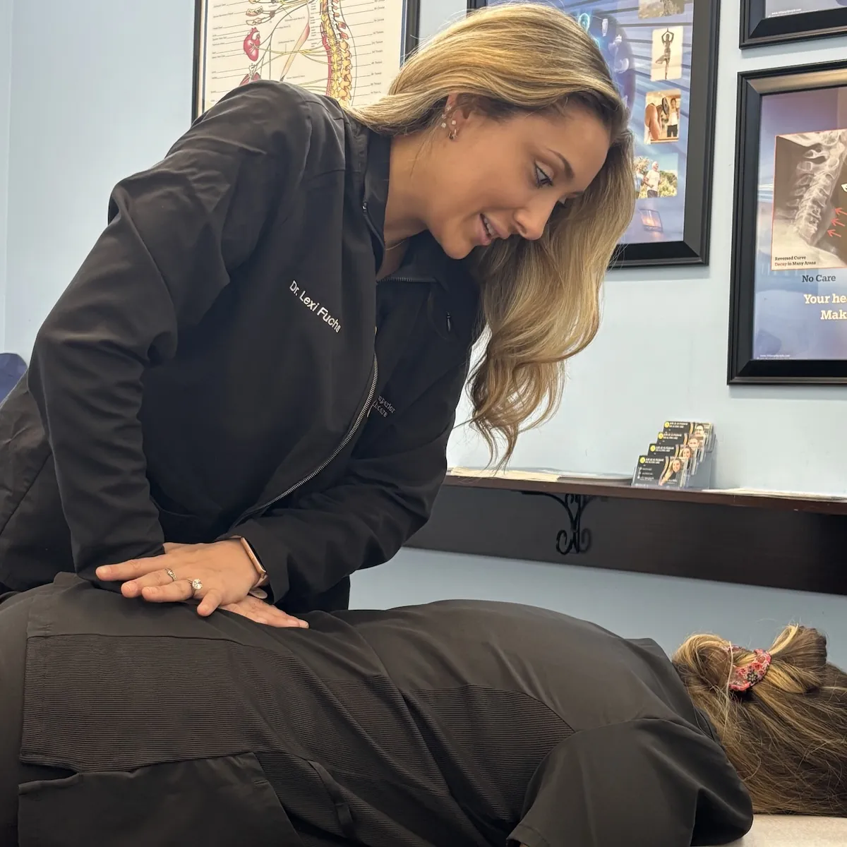 Dr. Lexi Fuchs adjusting a patient lying face down