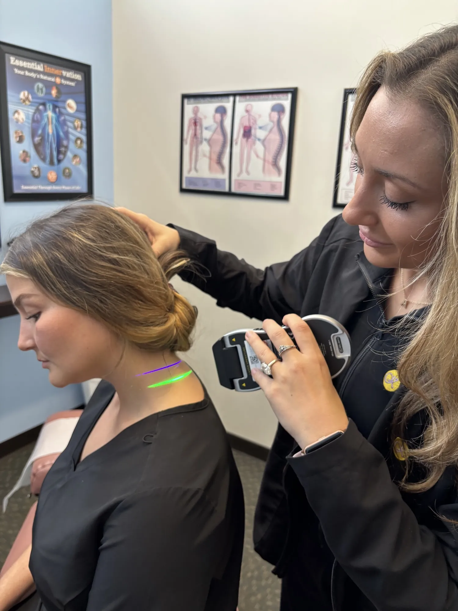 Dr. Lexi Fuchs giving cold laser therapy to a patient's neck