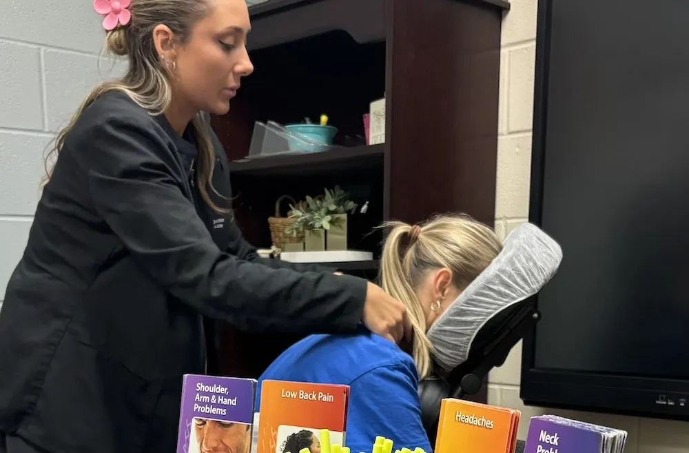 Chiropractor working with a guest at a community event