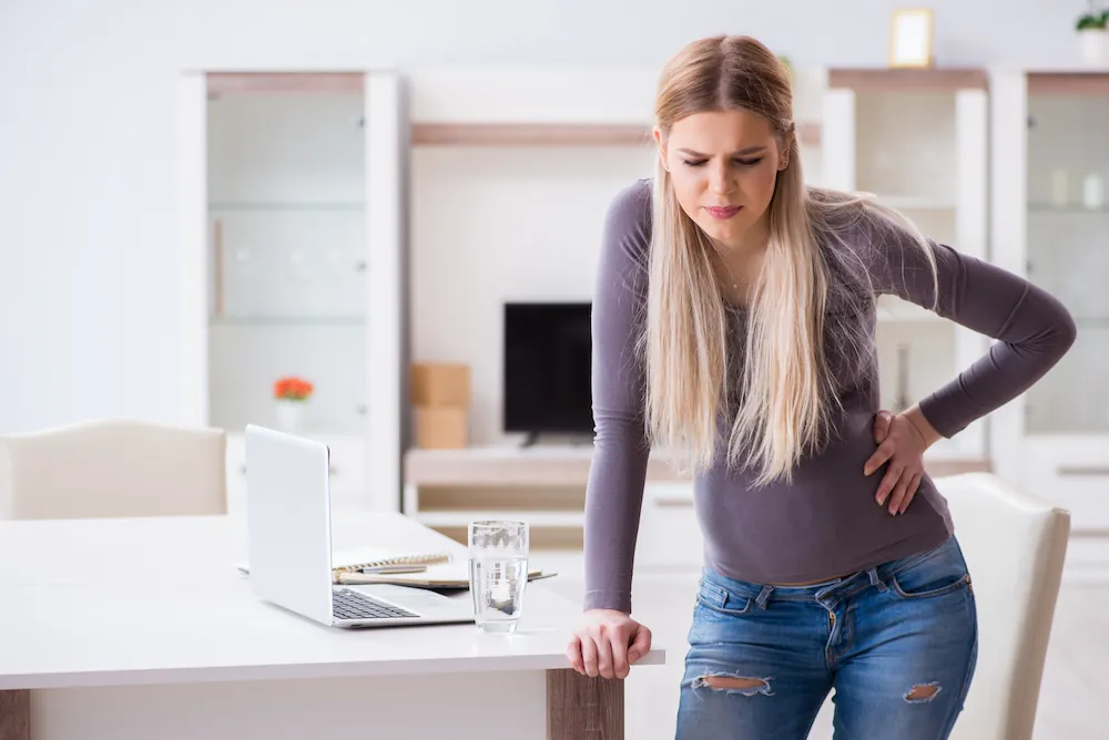 Pregnant businesswoman feeling sick at work