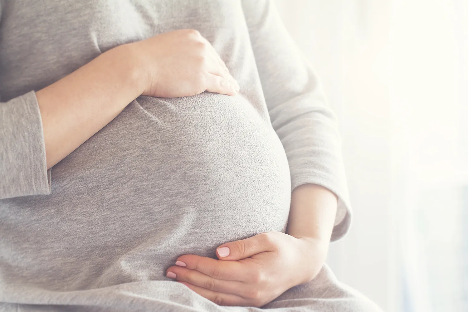 Pregnant woman holding her baby bump