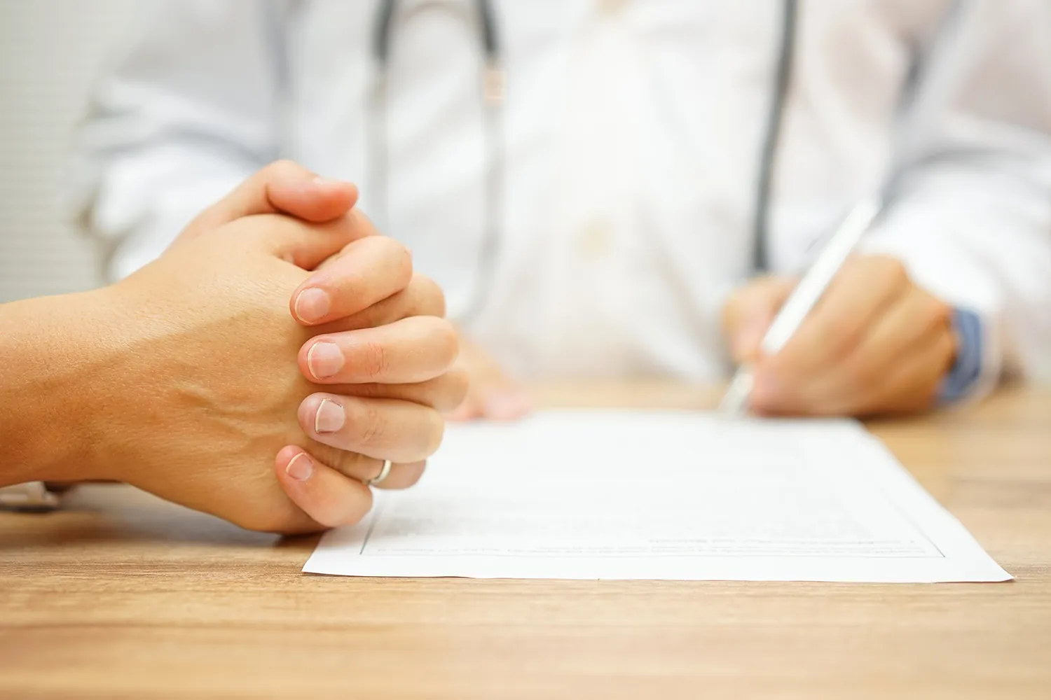 Patient reviewing paperwork with a doctor