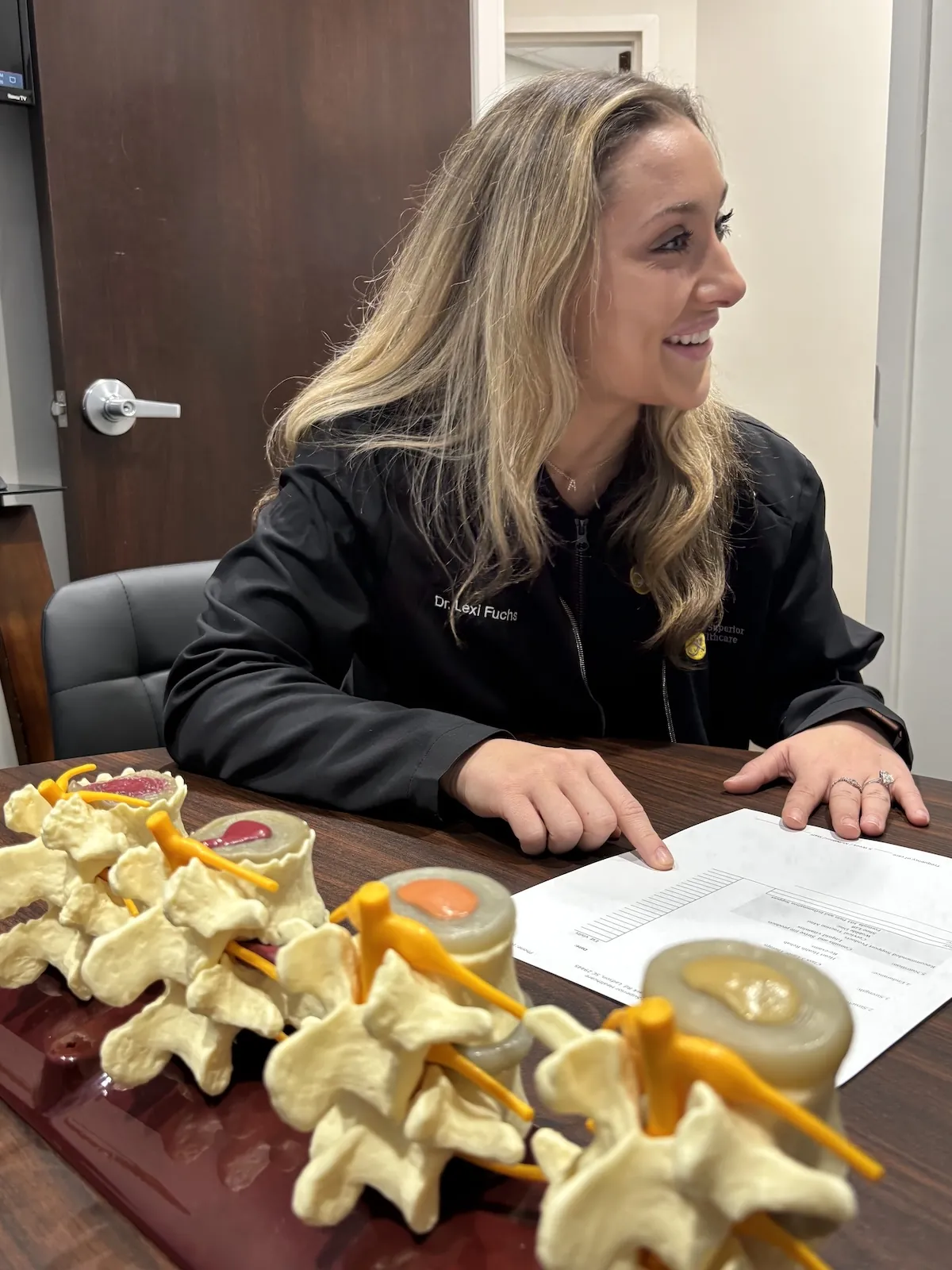 Chiropractor teaching with vertebrae models