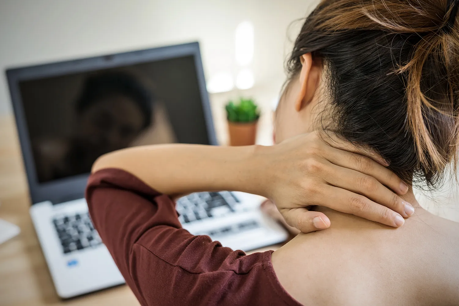 Woman with neck pain from working too long
