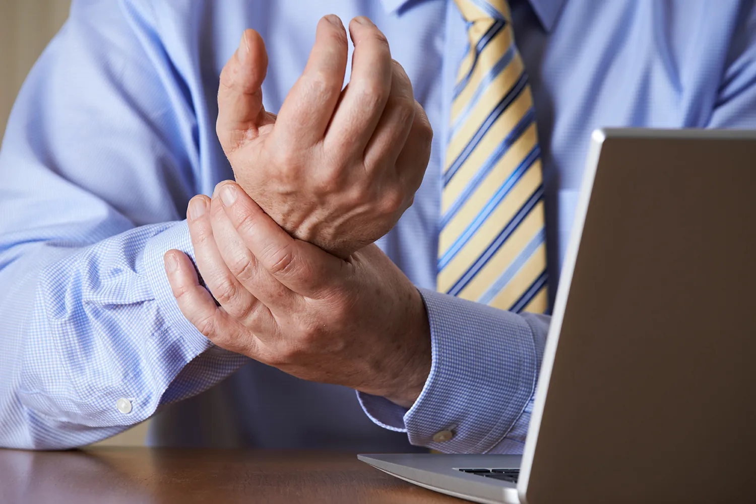 Man holding his wrist due to pain
