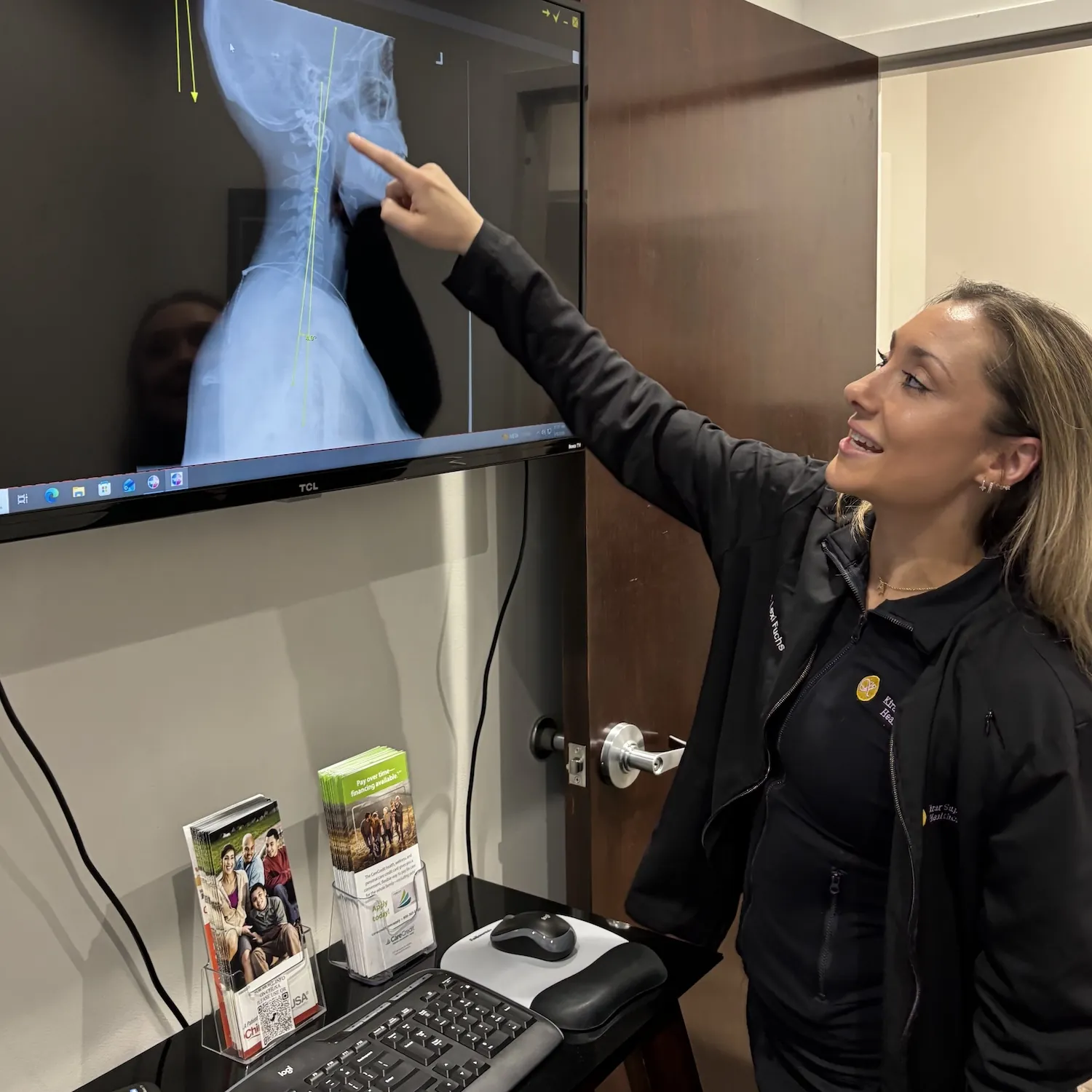 Dr. Lexi Fuchs reviewing a spine X-ray on screen